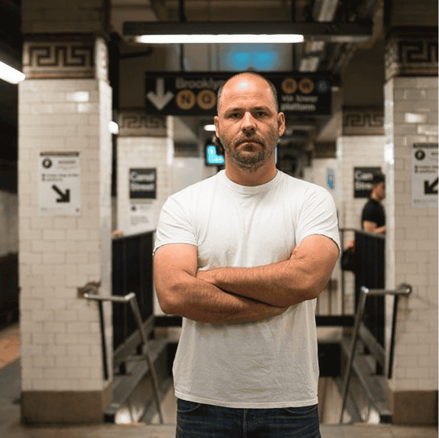 An image of Reso standing with his arms crossed
