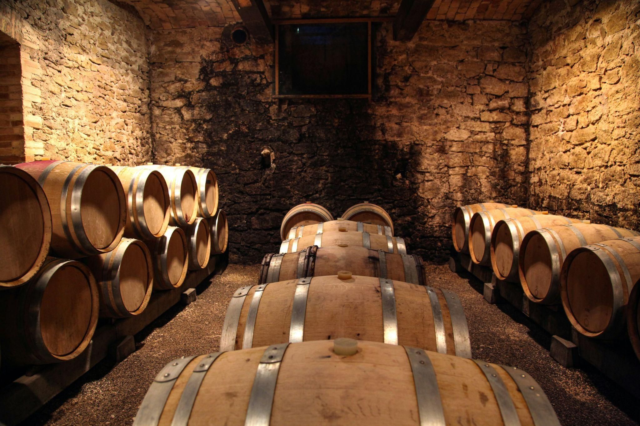 A modern, glass enclosed cellar filled with wine bottles
