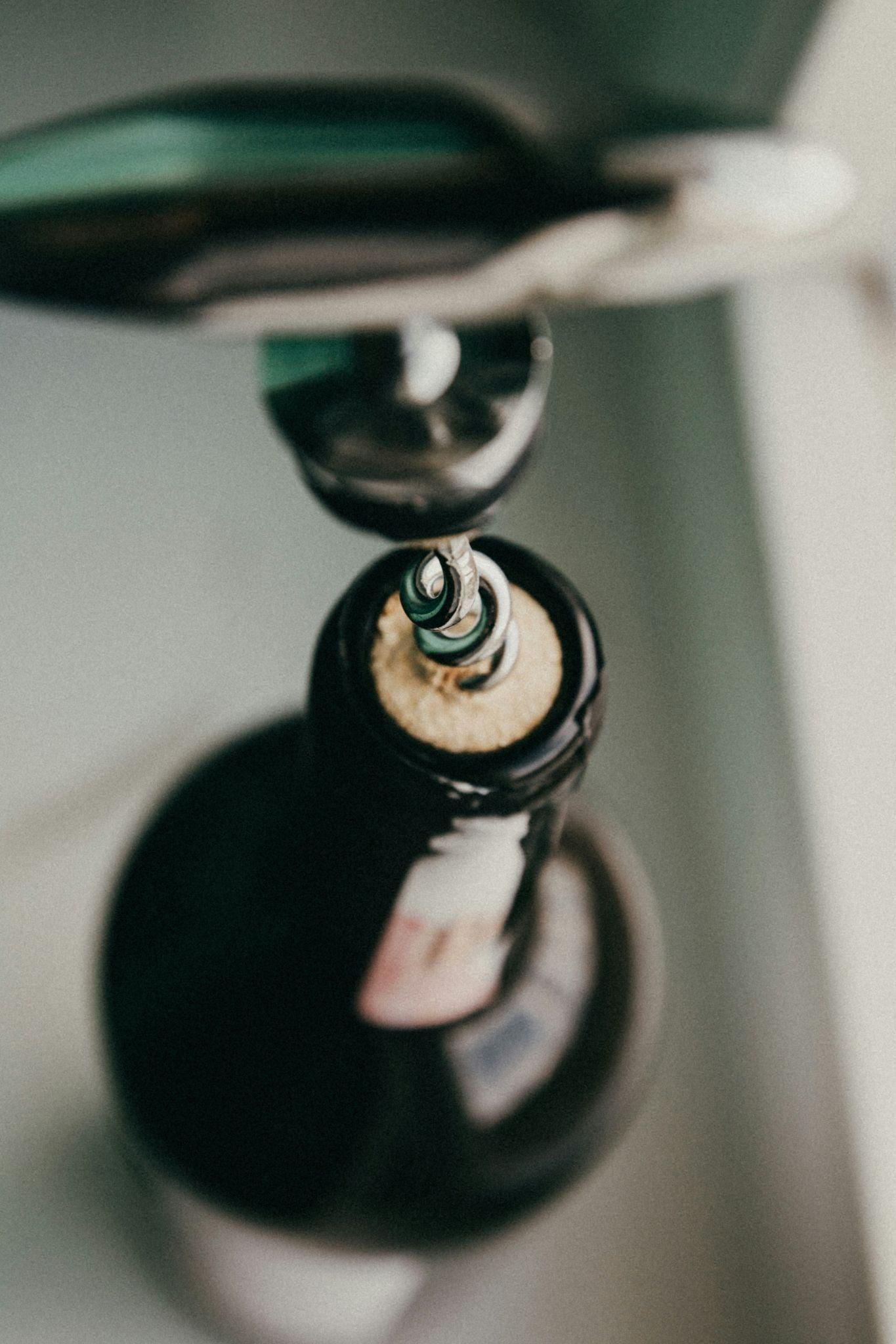 Bottle opener opening a bottle of wine